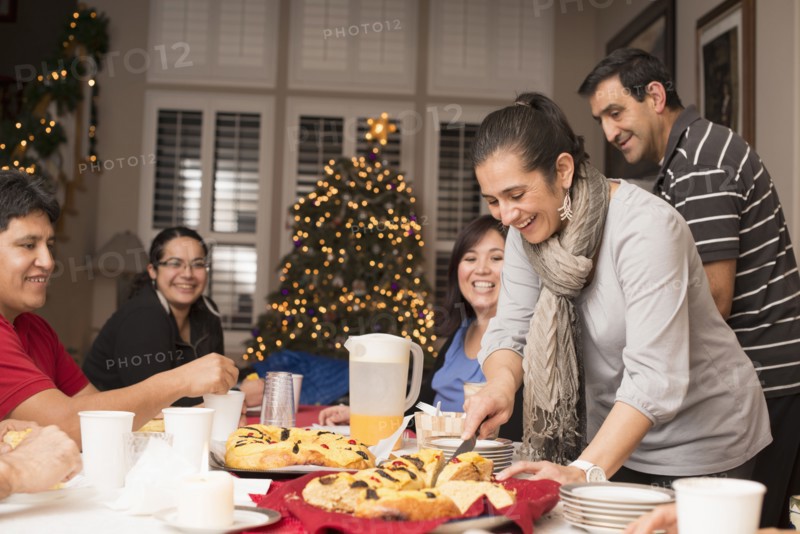 Hispanic family enjoying traditional Christmas dessert
