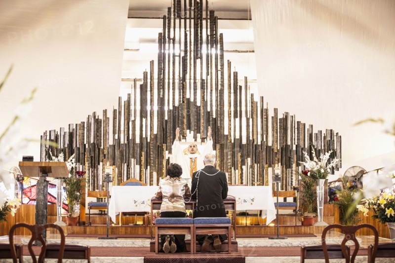 Couple praying at wedding in church