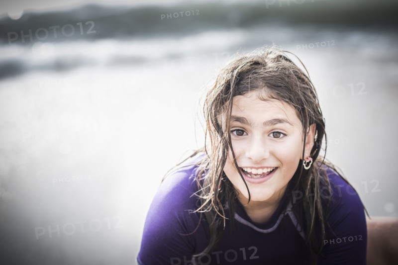 Mixed race girl with wet hair at beach