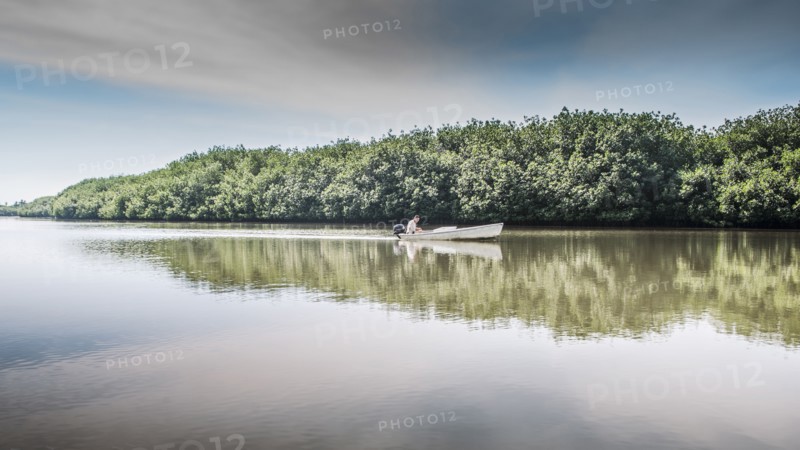 Canoe floating in still rural lake