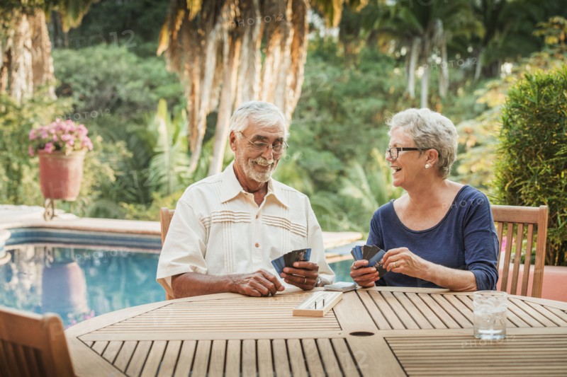 Caucasian couple playing cards outdoors