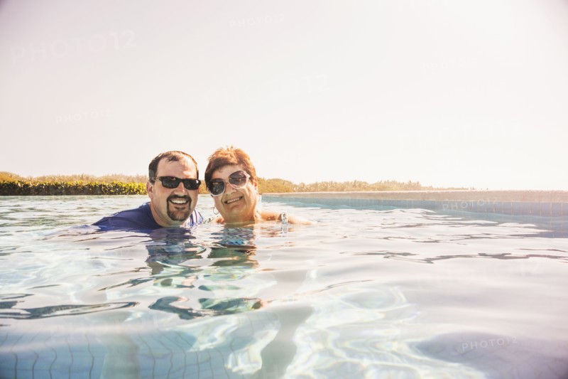 Mother and son smiling in swimming pool