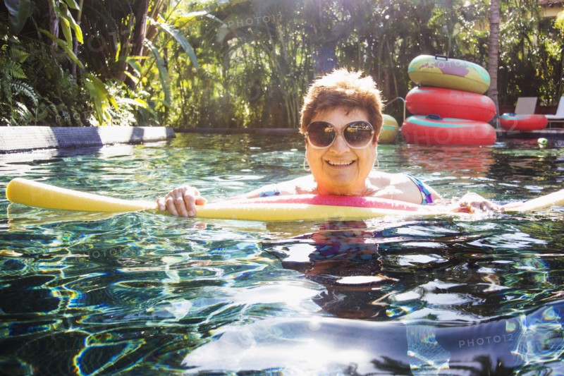 Older woman with sunglasses in swimming pool