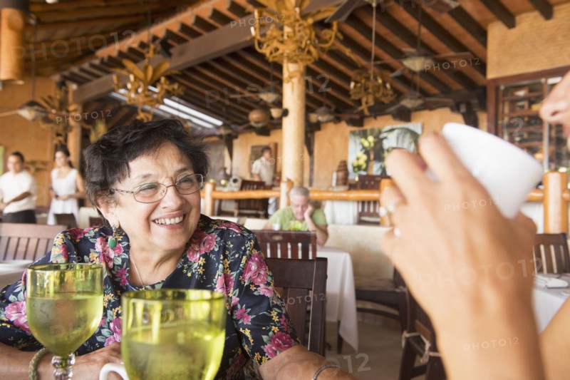 Older woman laughing in restaurant