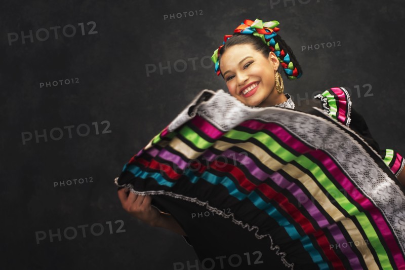 Hispanic teenage girl dancing in Jallisco Folkloric dress