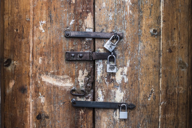 Close up of padlocks on secure door