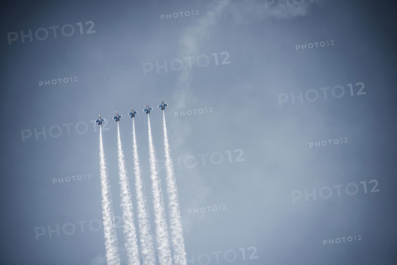 Jets flying in formation in cloudy blue sky