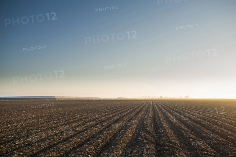 High angle view of farm crop fields under blue sky