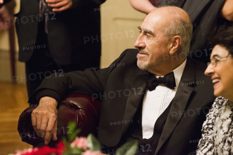 Hispanic family in formal wear sitting at wedding