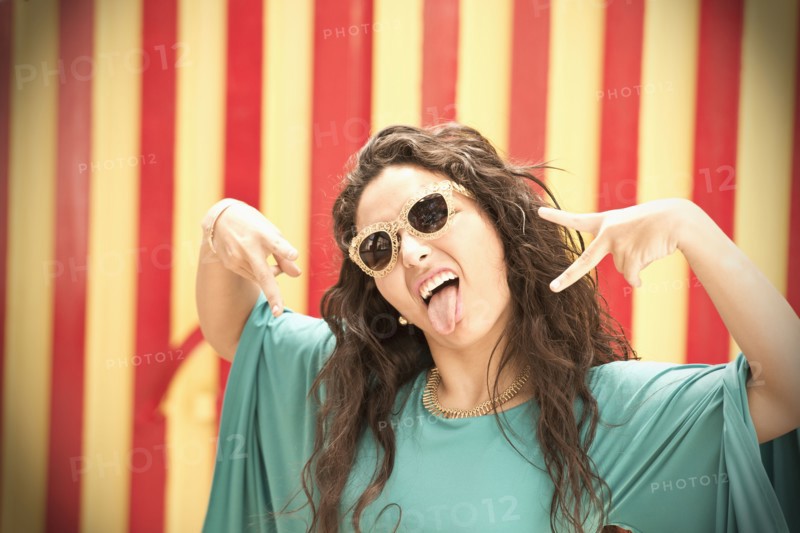 Hispanic woman in sunglasses making a face