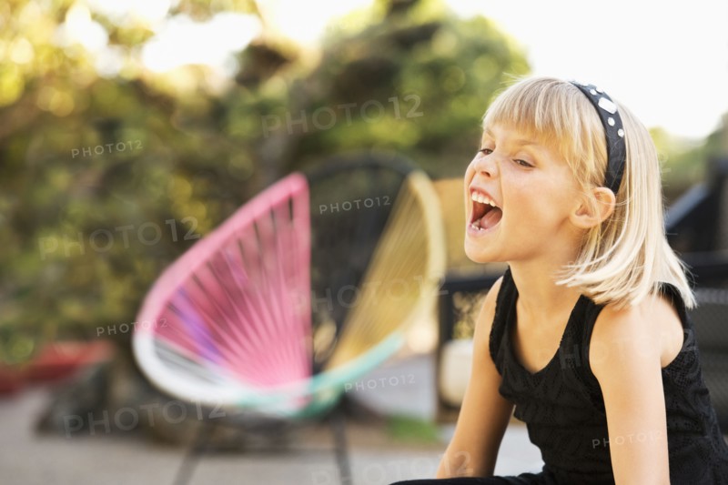 Caucasian girl shouting in backyard