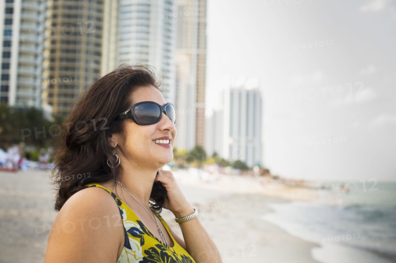 Hispanic woman standing on urban beach