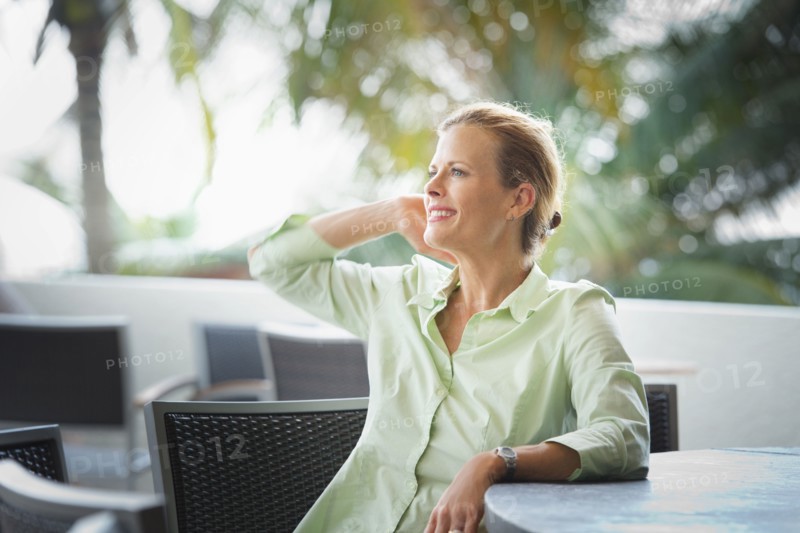 Woman sitting at patio bar