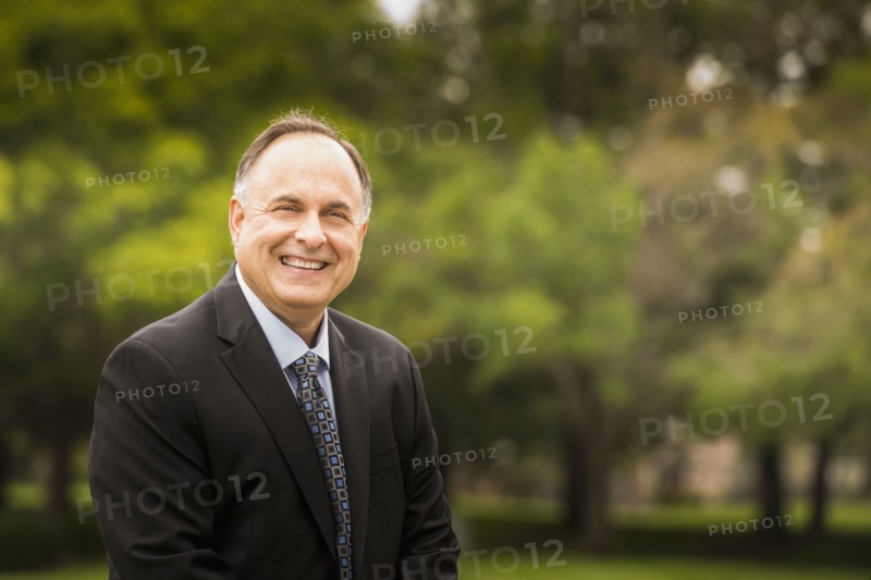 Caucasian businessman smiling in park