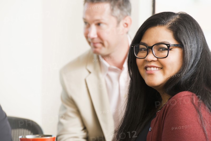 Businesswoman smiling in office meeting