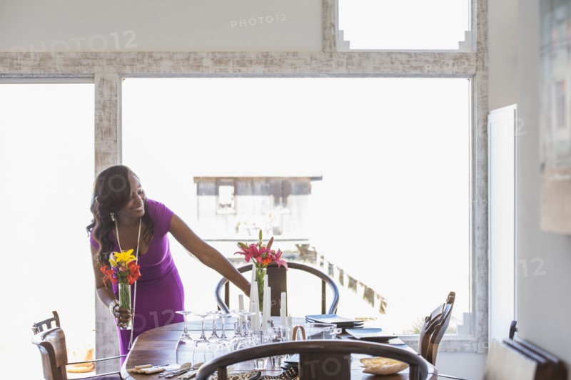 Woman setting dining table