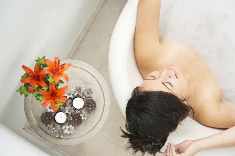 Woman relaxing in bubble bath