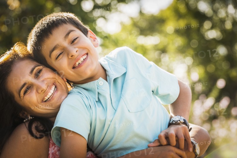 Mother and son hugging outdoors