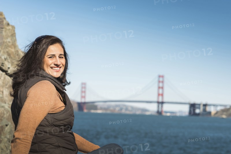 Mixed race woman smiling near Golden Gate Bridge view