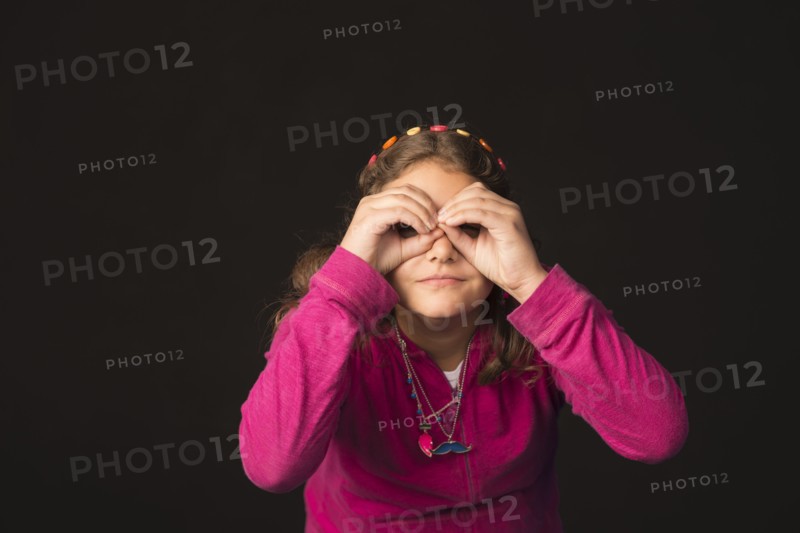 Mixed Race girl gesturing binoculars