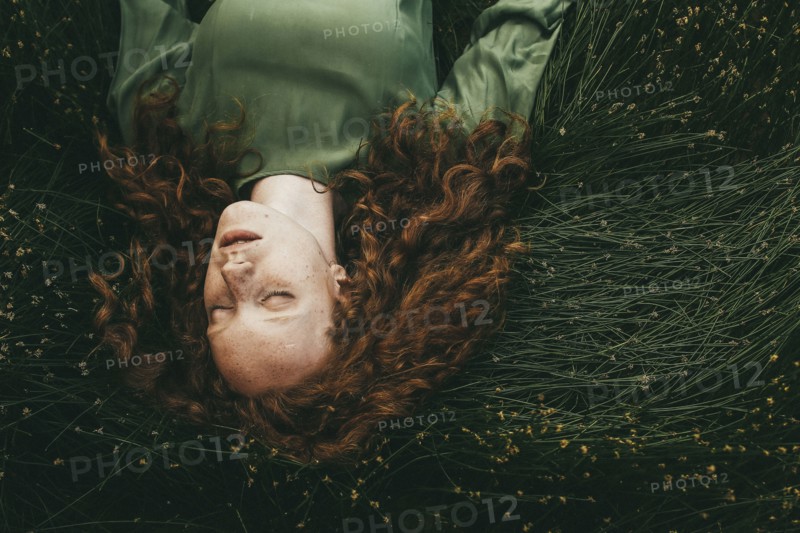 Caucasian girl sleeping in grass