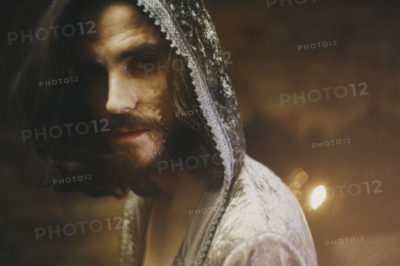 Caucasian man with beard wearing robe with hood