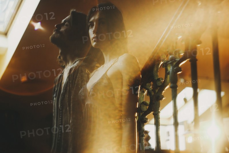 Double exposure of Caucasian couple and railing
