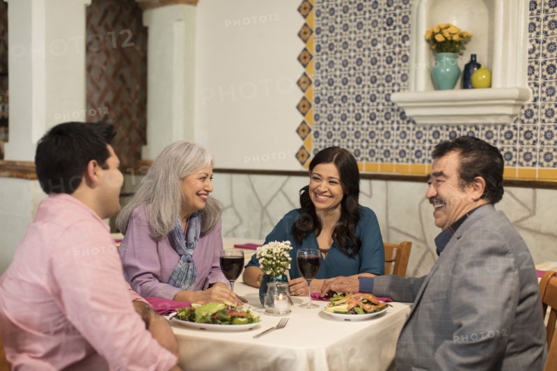 Couples laughing in restaurant
