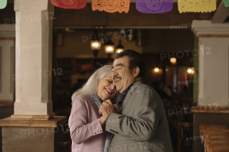 Older couple dancing in restaurant