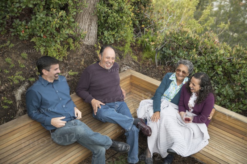 People sitting on bench and laughing