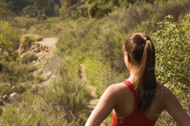 Hispanic woman looking at nature trail