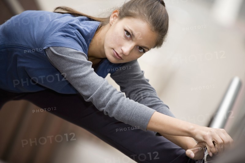 Hispanic woman stretching
