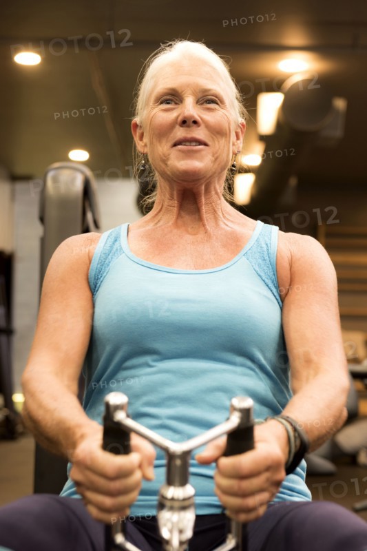 Smiling older woman working out in gymnasium
