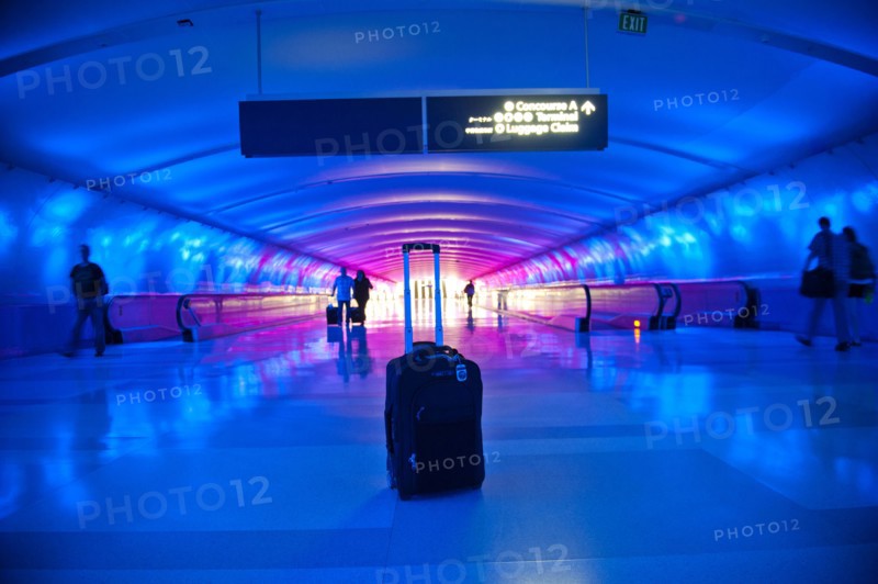 Abandoned suitcase in blue airport terminal