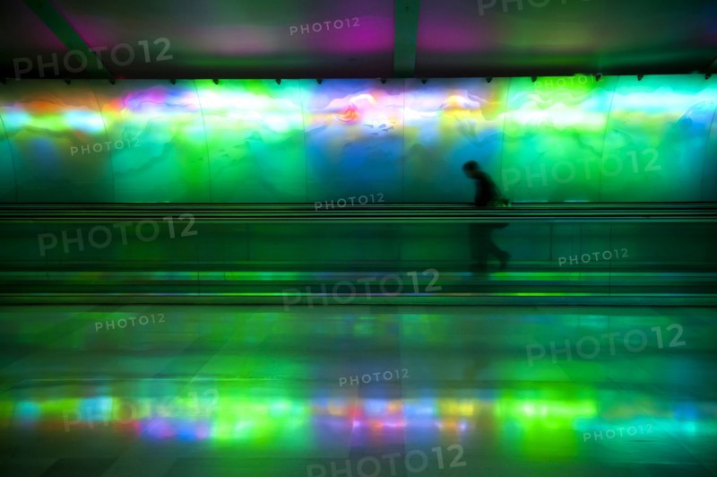 Silhouette of person on moving walkway