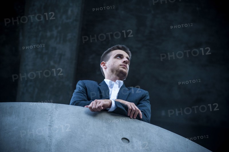 Low angle view of businessman leaning on balcony