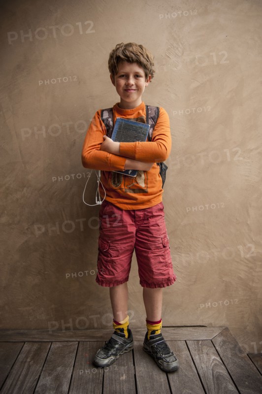 Portrait of smiling Caucasian boy holding book