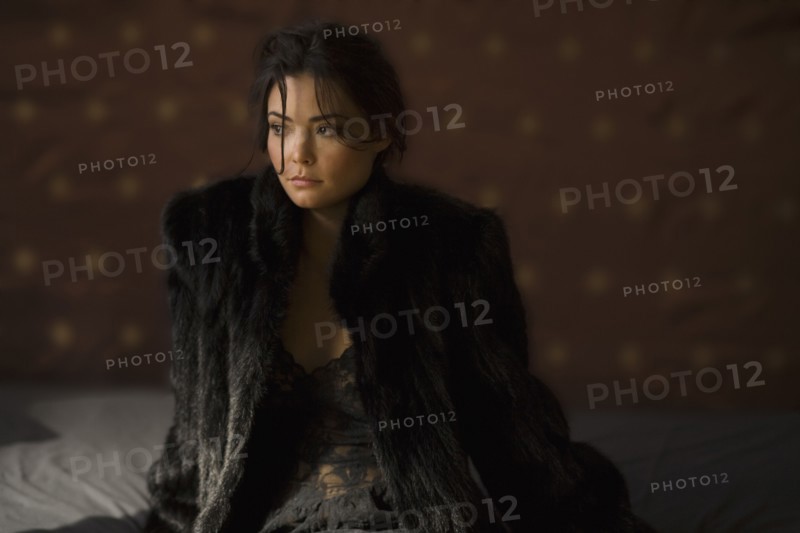 Serious Hispanic woman in fur coat