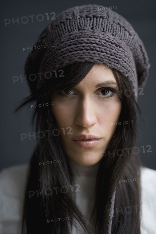 Serious mixed race woman wearing knit cap