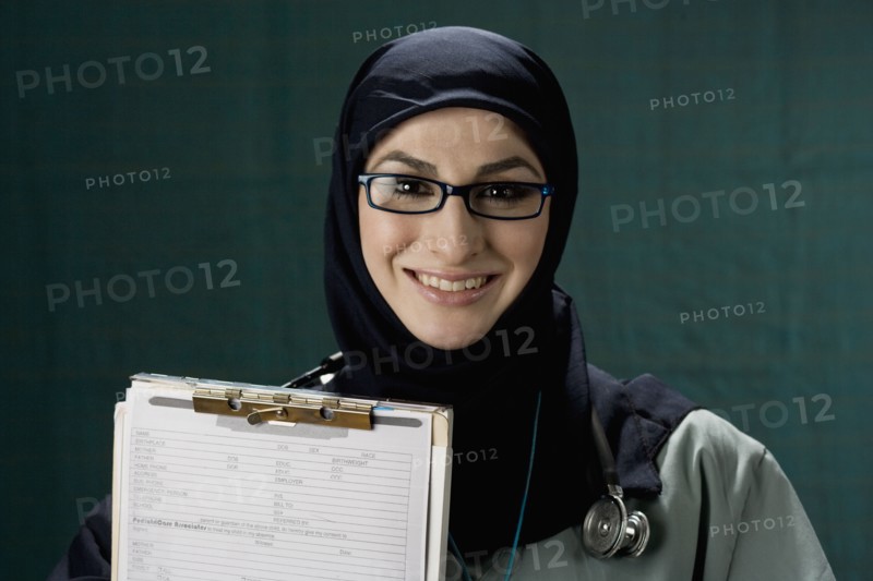 Middle Eastern doctor holding medical chart