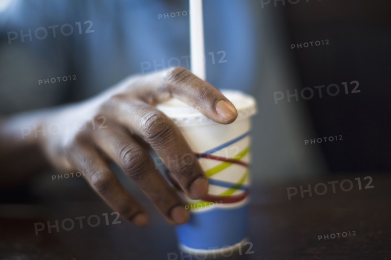 Black man holding soda cup