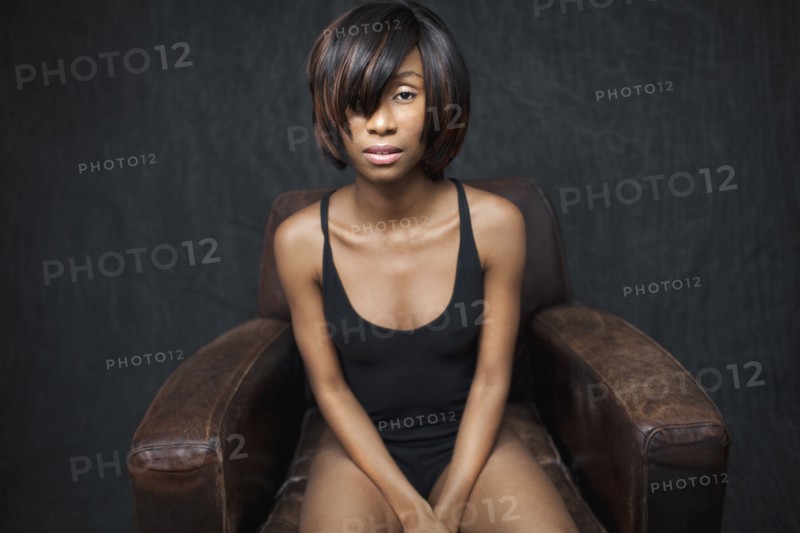 Black woman sitting in leather armchair