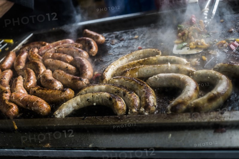 Links of meat cooking on grille