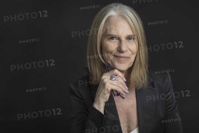 Portrait of smiling older Caucasian businesswoman holding eyeglasses
