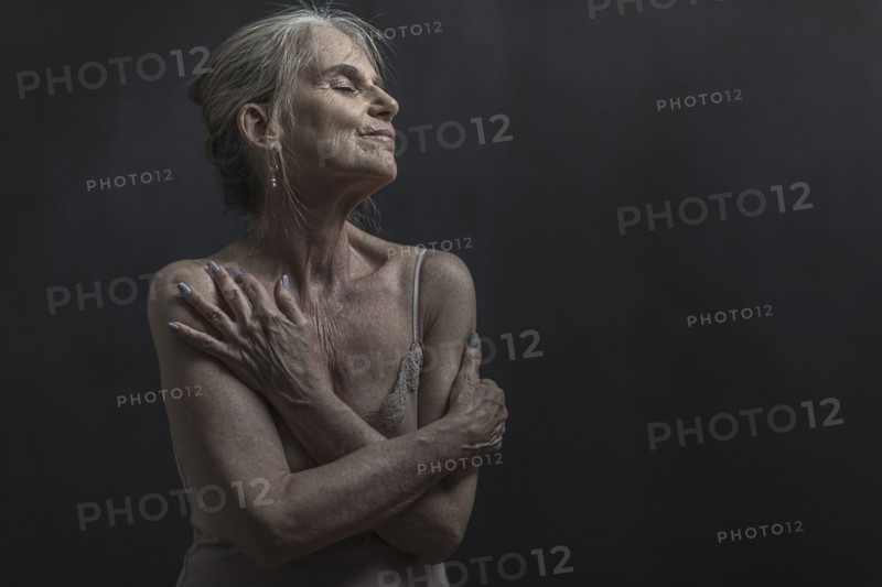 Portrait of daydreaming older Caucasian woman