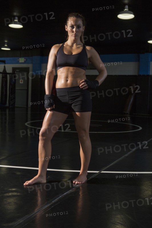 Caucasian fighter standing in gym
