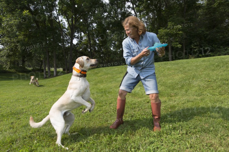 Caucasian woman playing with dog in park