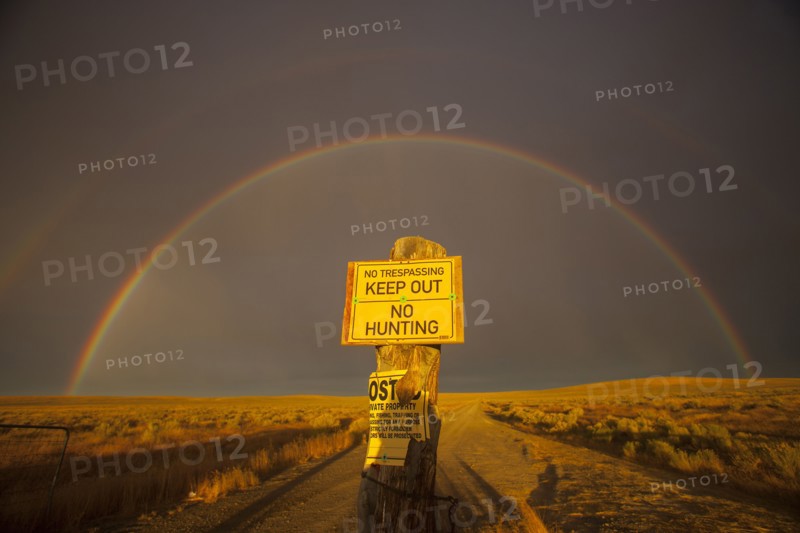 Warning sign in private fields under rainbow