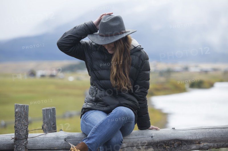 Caucasian woman sitting at rural river