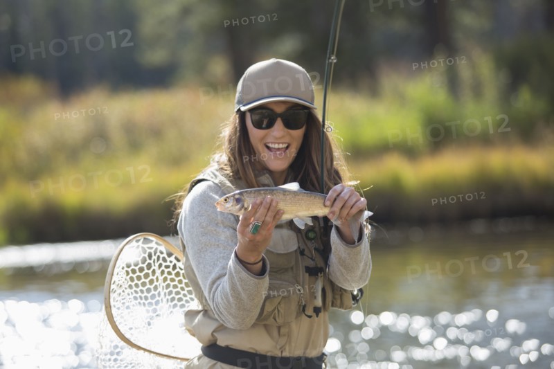 Caucasian woman displaying fishing catch